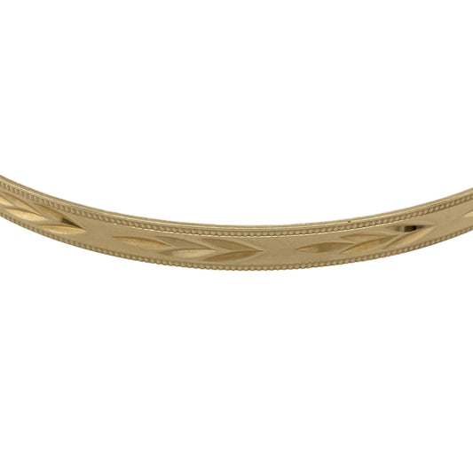 Add refined elegance and classic detail to your jewellery collection with this pre-owned 9ct yellow solid gold patterned bangle, offering a slim and timeless design.

Design: This bangle features a patterned finish across the surface, adding subtle texture while maintaining a traditional and elegant look.
Material: Made from solid 9-carat yellow gold, the warm polished tone enhances the decorative pattern and gives the bangle lasting appeal.