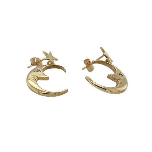 Add celestial charm and delicate sparkle to your jewellery collection with these pre-owned 9ct yellow gold and cubic zirconia set crescent moon and star drop earrings, offering graceful movement and eye-catching detail. Perfect for both everyday styling and evening wear.

Design: Each earring features a crescent moon and star motif in a drop design, symbolising guidance and light. The flowing silhouette creates elegant movement, while the star detailing adds a playful yet refined finish.