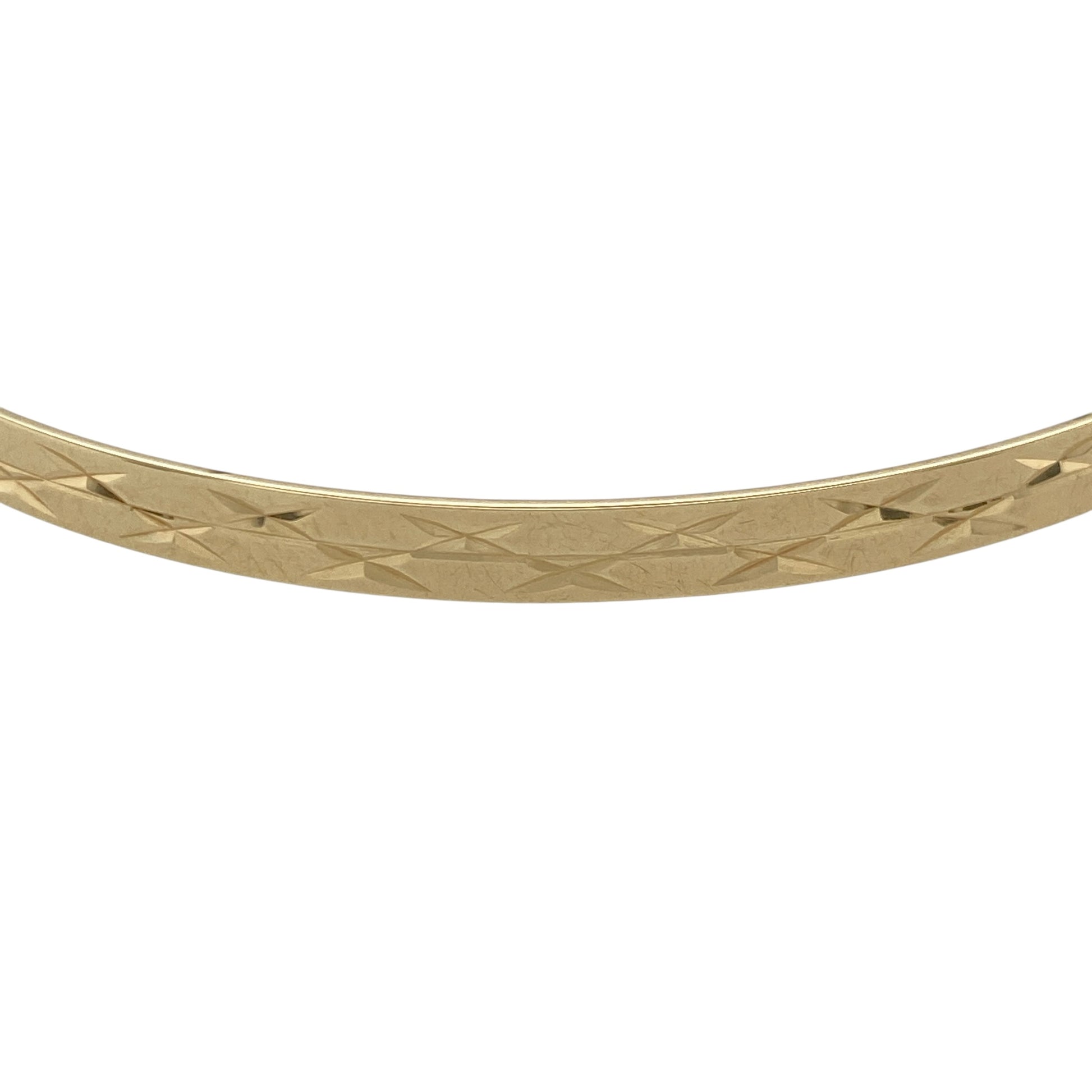 Add refined sparkle to your jewellery collection with this pre-owned 9ct yellow solid gold diamond cut patterned bangle, combining classic style with light-catching detail. A timeless piece ideal for everyday wear or elegant layering.

Design: Measuring approximately 4mm in width, the bangle features a diamond cut patterned finish that creates a faceted surface, reflecting light beautifully with every movement. The slim yet defined profile offers a balanced and sophisticated look on the wrist.