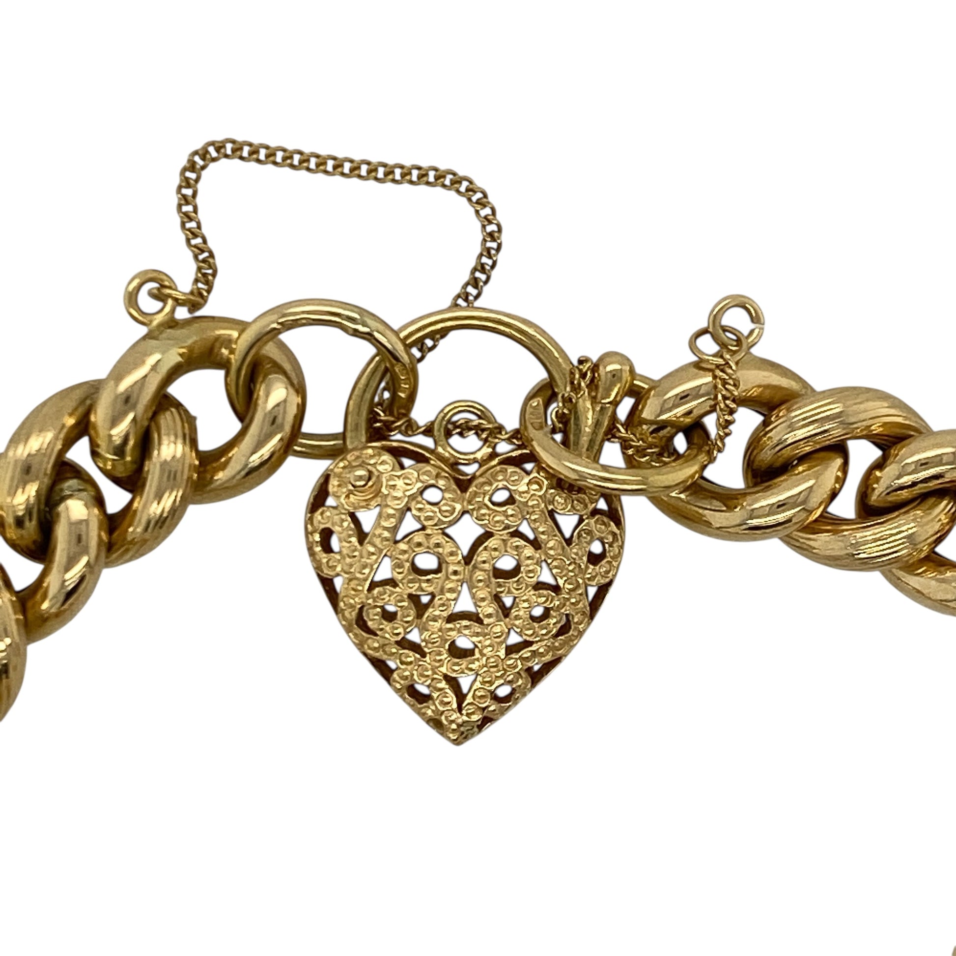 Make a bold and timeless statement with this pre-owned 18ct yellow gold open patterned heart padlock curb charm bracelet, combining classic design with substantial weight and luxurious appeal. A standout piece perfect for everyday elegance or special occasions.

Design: The bracelet features a traditional 7" curb link design measuring approximately 10mm in width, creating a strong and eye-catching profile on the wrist.