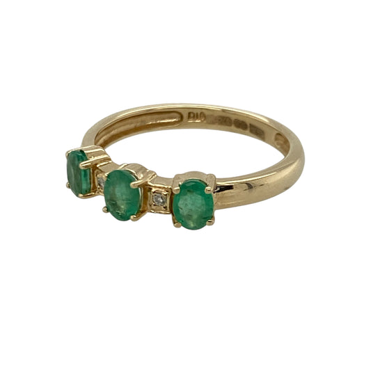 Add timeless colour and delicate sparkle to your jewellery collection with this pre-owned 9ct yellow gold diamond and emerald set trilogy band ring, combining classic gemstone styling with elegant detail. A refined piece perfect for everyday wear or meaningful gifting.

Design: The ring features three oval-cut emeralds, each measuring approximately 4mm by 3mm, arranged in a traditional trilogy formation.