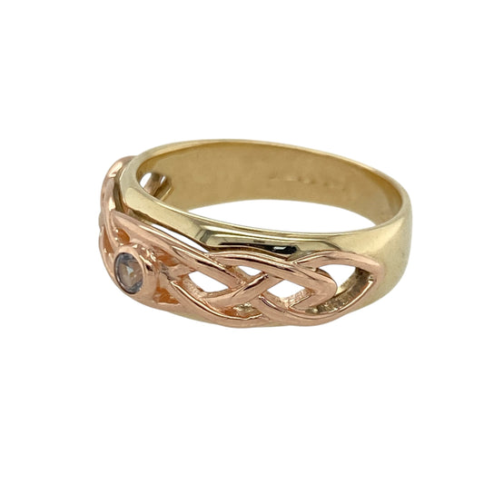 Celebrate heritage and meaningful design with this pre-owned 9ct yellow and rose gold blue stone Clogau Celtic Knot band ring, combining symbolic detailing with elegant two-tone styling. A distinctive piece perfect for everyday wear or a thoughtful gift.

Design: The front of the band measures approximately 8mm wide and features an intricate Celtic Knot motif flowing across the surface.