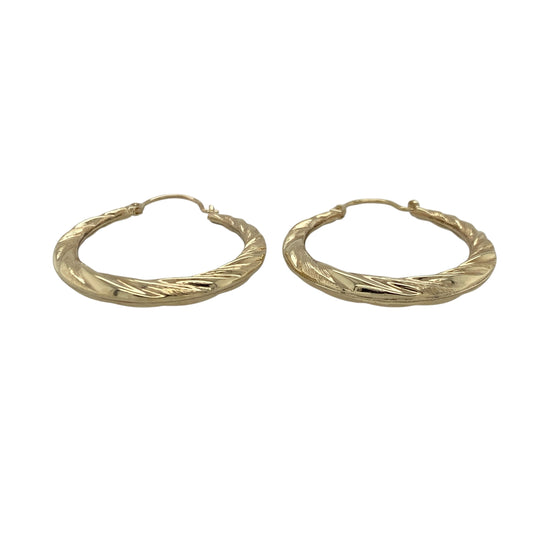 Add effortless elegance to your jewellery collection with these pre-owned 9ct yellow gold twisted hoop creole earrings, offering timeless styling with subtle texture. A versatile pair perfect for everyday wear or easy day-to-evening accessorising.

Design: The earrings feature a classic hoop creole silhouette enhanced by a gentle twisted design. The flowing curves create light-catching detail, giving the hoops added dimension while maintaining a refined and wearable profile.