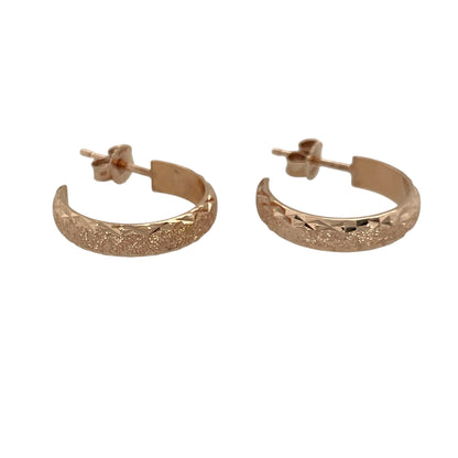 Add warm tones and subtle shimmer to your jewellery collection with these pre-owned 9ct rose gold sparkle patterned half hoop earrings, a stylish and feminine choice for everyday wear.

Design: These earrings feature a classic half hoop profile enhanced by a sparkle-cut patterned finish, designed to catch the light beautifully. The curved shape sits neatly against the ear, offering a flattering and contemporary look.