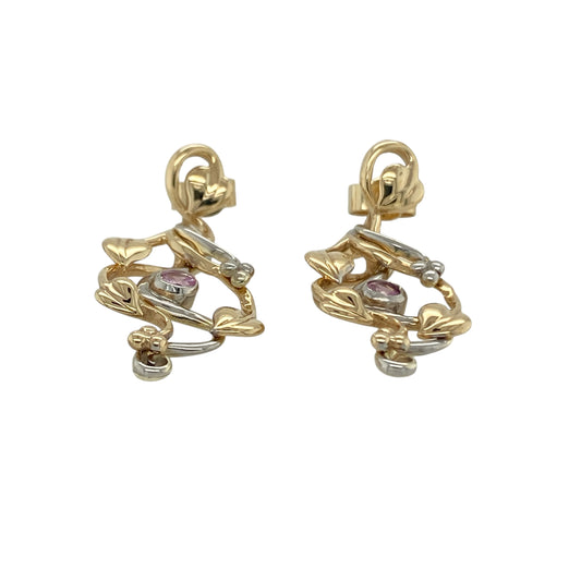 Celebrate iconic Welsh design with these pre-owned 9ct yellow and white gold pink sapphire set Clogau Tree of Life drop earrings, a meaningful and elegant pair perfect for special occasions or refined everyday wear.

Design: The earrings feature the signature Tree of Life motif, symbolising growth, strength and new beginnings. Each drop is enhanced with a round pink sapphire measuring approximately 3mm in diameter, adding a beautiful pop of colour and feminine charm.