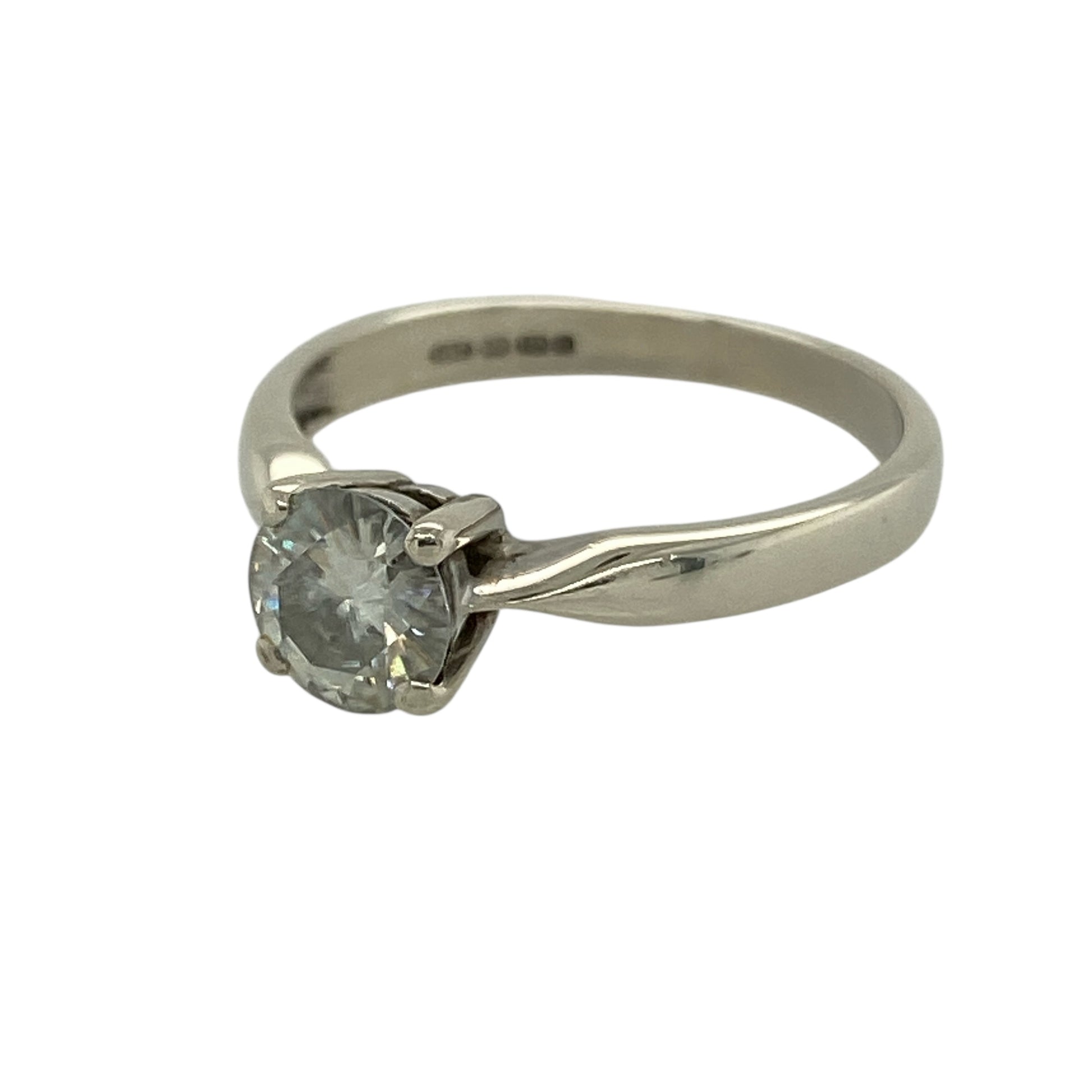 Make a sparkling statement with this pre-owned 9ct white gold moissanite set solitaire ring, a timeless and elegant piece perfect for engagements, special occasions or refined everyday wear.

Design: The ring features a single round brilliant-cut moissanite measuring approximately 6mm in diameter, creating impressive fire and brilliance. The classic solitaire setting allows maximum light to pass through the stone, enhancing its exceptional sparkle and clean, sophisticated profile.
