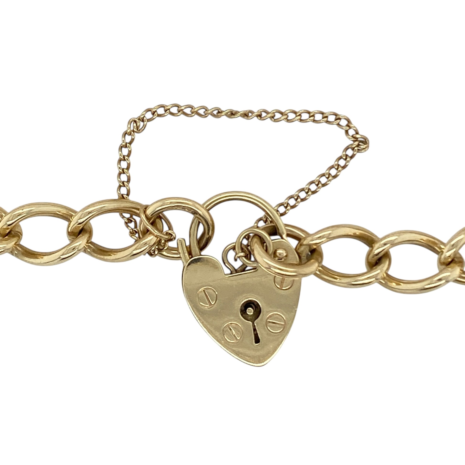 Make a timeless statement with this pre-owned 9ct yellow gold 7" heart padlock curb link charm bracelet, a classic and substantial piece perfect for everyday wear or meaningful gifting.

Design: This bracelet features traditional curb links measuring approximately 6mm in width, creating a bold and structured profile on the wrist. The iconic heart-shaped padlock clasp adds romantic charm and vintage appeal, making it a standout feature.