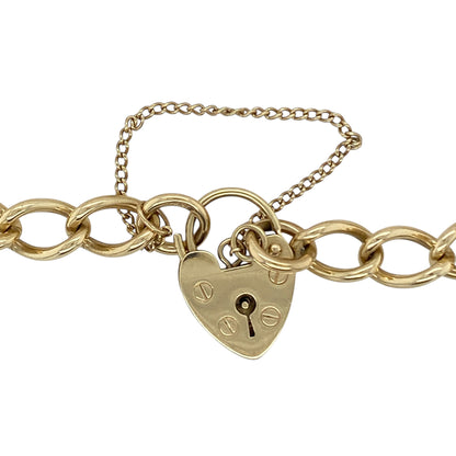 Make a timeless statement with this pre-owned 9ct yellow gold 7" heart padlock curb link charm bracelet, a classic and substantial piece perfect for everyday wear or meaningful gifting.

Design: This bracelet features traditional curb links measuring approximately 6mm in width, creating a bold and structured profile on the wrist. The iconic heart-shaped padlock clasp adds romantic charm and vintage appeal, making it a standout feature.