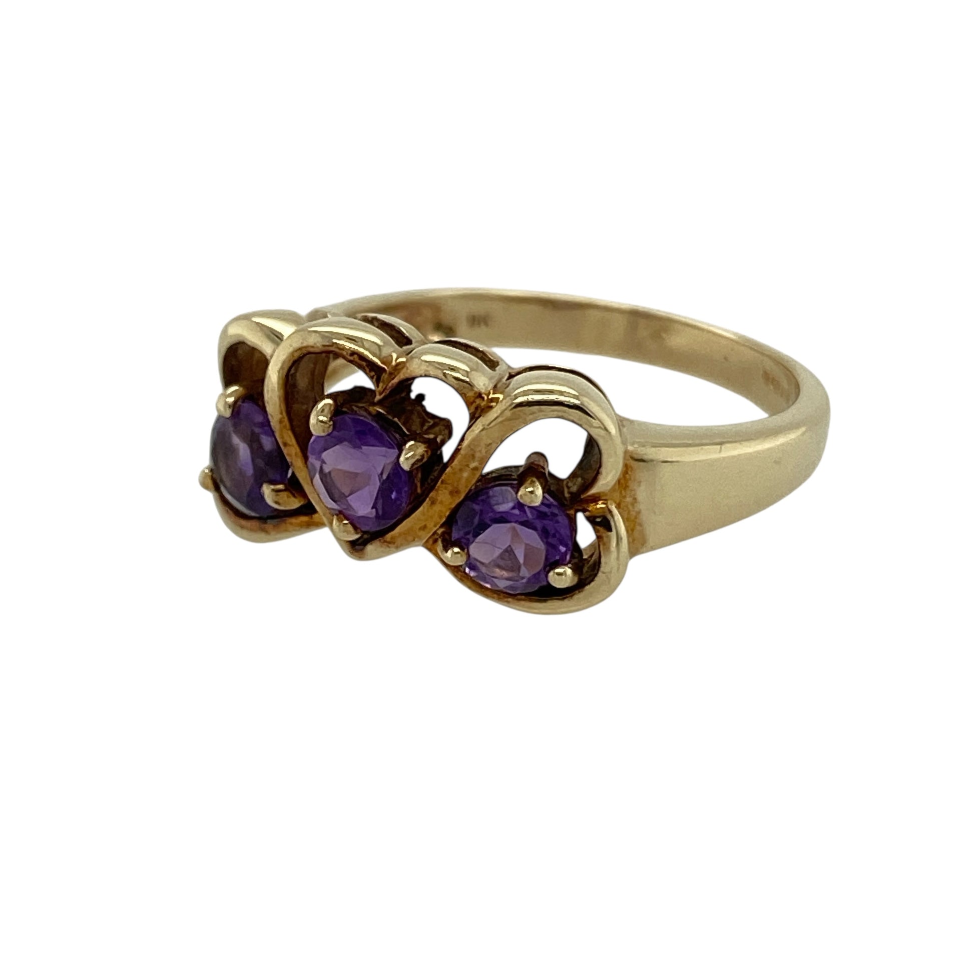 Add romantic colour to your jewellery collection with this pre-owned 9ct yellow gold amethyst set three heart ring, a meaningful and eye-catching piece perfect for everyday wear or gifting.

Design: The ring features three heart-shaped settings across the front, measuring approximately 9mm high. Each heart is set with a round amethyst measuring around 4mm in diameter, creating a beautiful trio of rich purple tones with balanced sparkle and symmetry.