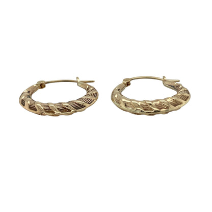 Add subtle texture to your jewellery collection with these pre-owned 9ct yellow gold twist patterned hoop creole earrings, a timeless and easy-to-wear pair perfect for everyday styling.

Design: These earrings feature a classic hoop creole shape enhanced with a delicate twist pattern, creating light-catching detail and added dimension. The gently sculpted profile offers a refined and feminine look while maintaining a traditional hoop silhouette.