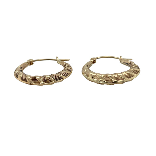 Add subtle texture to your jewellery collection with these pre-owned 9ct yellow gold twist patterned hoop creole earrings, a timeless and easy-to-wear pair perfect for everyday styling.

Design: These earrings feature a classic hoop creole shape enhanced with a delicate twist pattern, creating light-catching detail and added dimension. The gently sculpted profile offers a refined and feminine look while maintaining a traditional hoop silhouette.