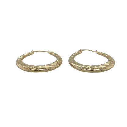 Add effortless elegance to your jewellery collection with these pre-owned 9ct yellow gold twisted hoop creole earrings, a lightweight and timeless pair perfect for everyday wear.

Design: These earrings feature a classic hoop creole silhouette with a subtle twisted design, creating gentle texture and light reflection. The flowing twist detail gives a refined and feminine touch while maintaining a simple, versatile style.