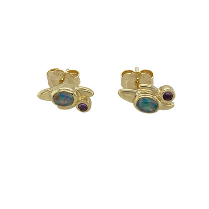 Add elegant colour and iconic Welsh design to your jewellery collection with these pre-owned 9ct yellow gold amethyst and opalique set Clogau stud earrings, a beautiful pair perfect for everyday wear or special occasions.

Design: These stud earrings showcase a striking combination of rich purple amethyst and luminous opalique stones, creating a soft yet eye-catching contrast. The balanced arrangement highlights the vibrant gemstone tones while maintaining a refined and feminine look.