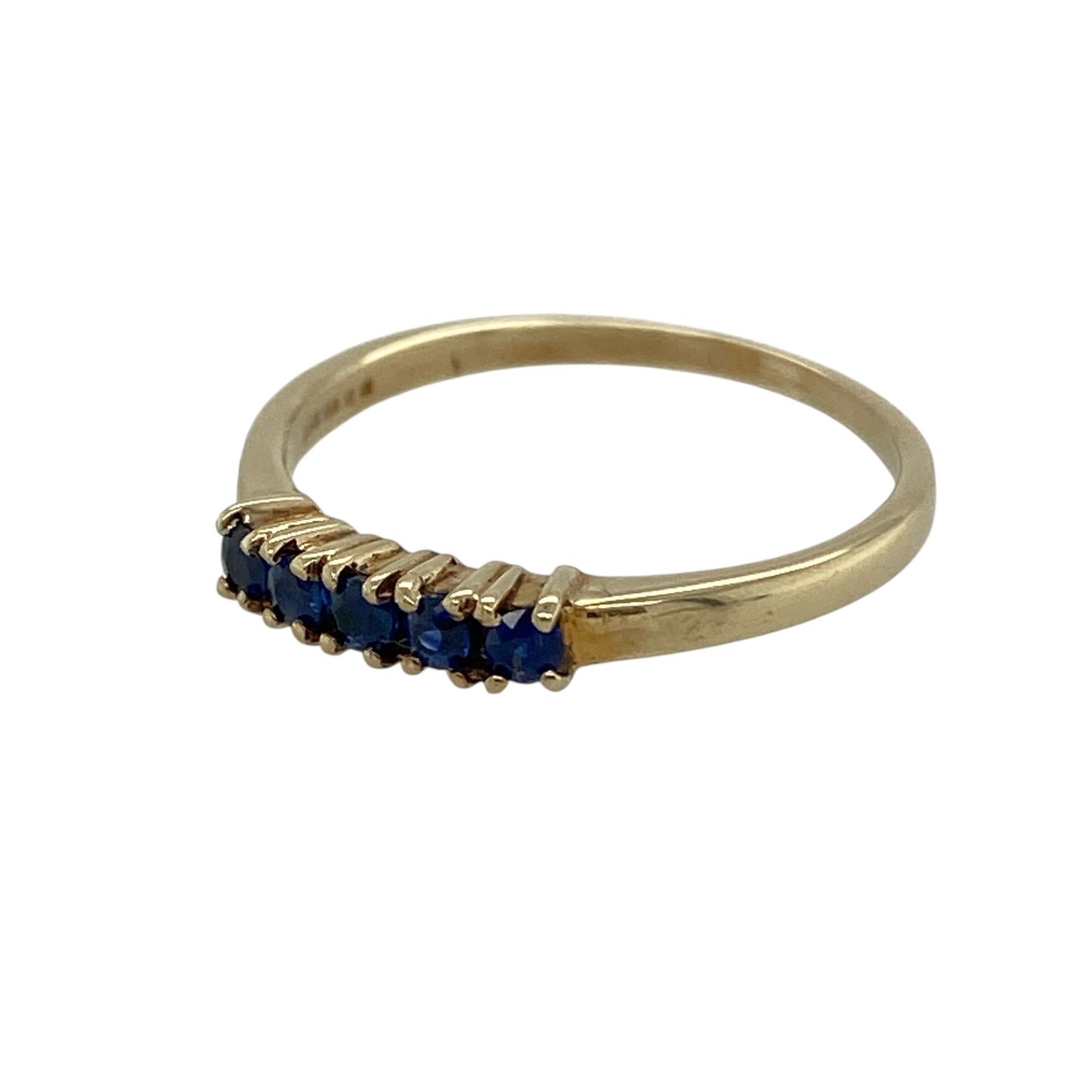 Add a touch of rich blue colour to your jewellery collection with this pre-owned 9ct yellow gold sapphire coloured stones set band ring—perfect for stacking, everyday wear or as a delicate eternity-style piece.

Design: The band is adorned with five round sapphire coloured stones, each measuring approximately 2mm in diameter, evenly spaced for a balanced and elegant look. The vibrant blue tones contrast beautifully against the yellow gold, creating a timeless and versatile design.