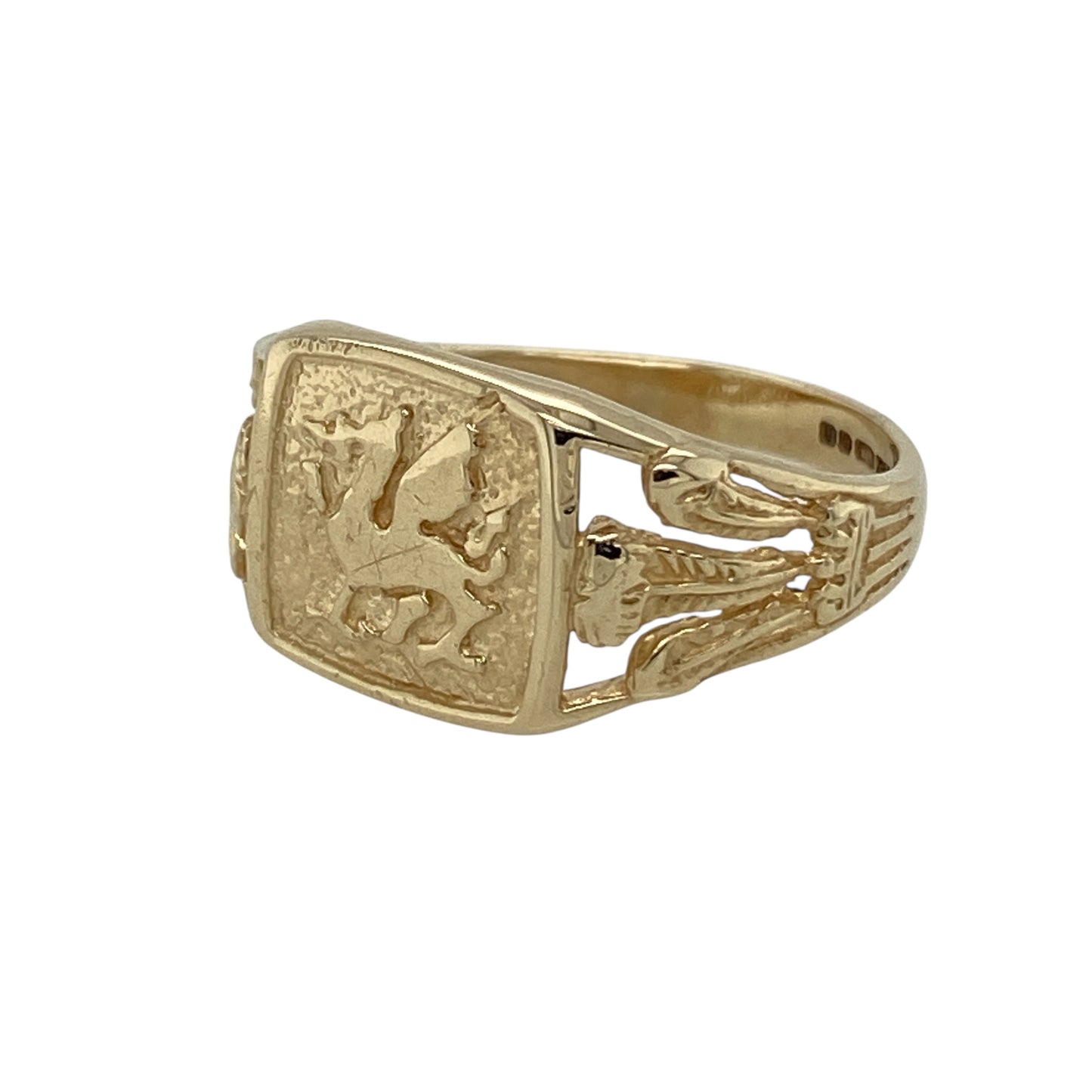 Showcase heritage and bold symbolism with this pre-owned 9ct yellow gold Welsh Dragon signet ring—an eye-catching piece rich in traditional detail and national pride.

Design: The signet head measures approximately 10mm high and features the iconic Welsh Dragon emblem at its centre, creating a strong and distinctive focal point. The shoulders are adorned with three feather symbols, adding further heritage detail and character to the overall design.