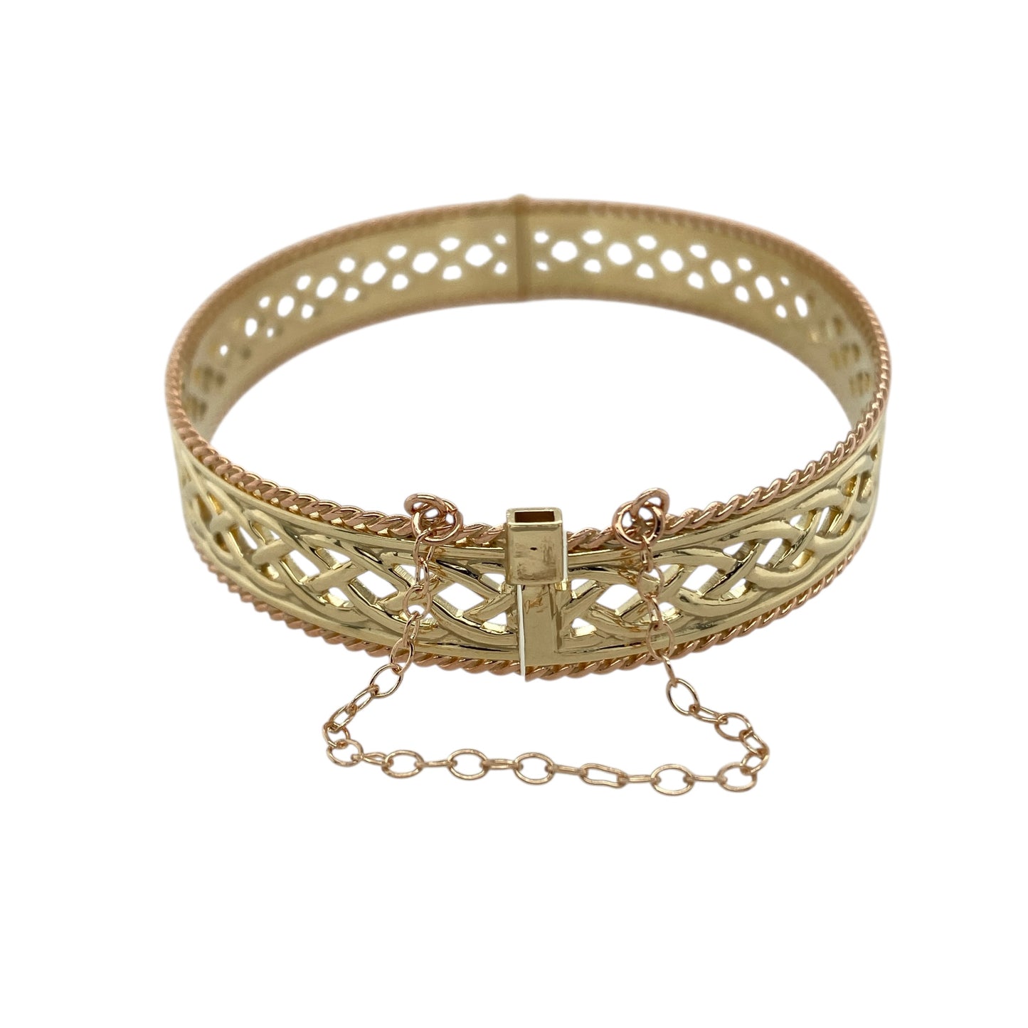 Celebrate heritage and craftsmanship with this pre-owned 9ct yellow and rose gold Clogau open Celtic weave bangle—a striking statement piece rich in traditional Welsh design.

Design: The bangle features an intricate open Celtic weave pattern across the centre, framed by a detailed rope edge that adds texture and definition. The 10mm width gives the piece a bold and eye-catching presence, while the 6cm diameter offers a comfortable and flattering fit on the wrist.