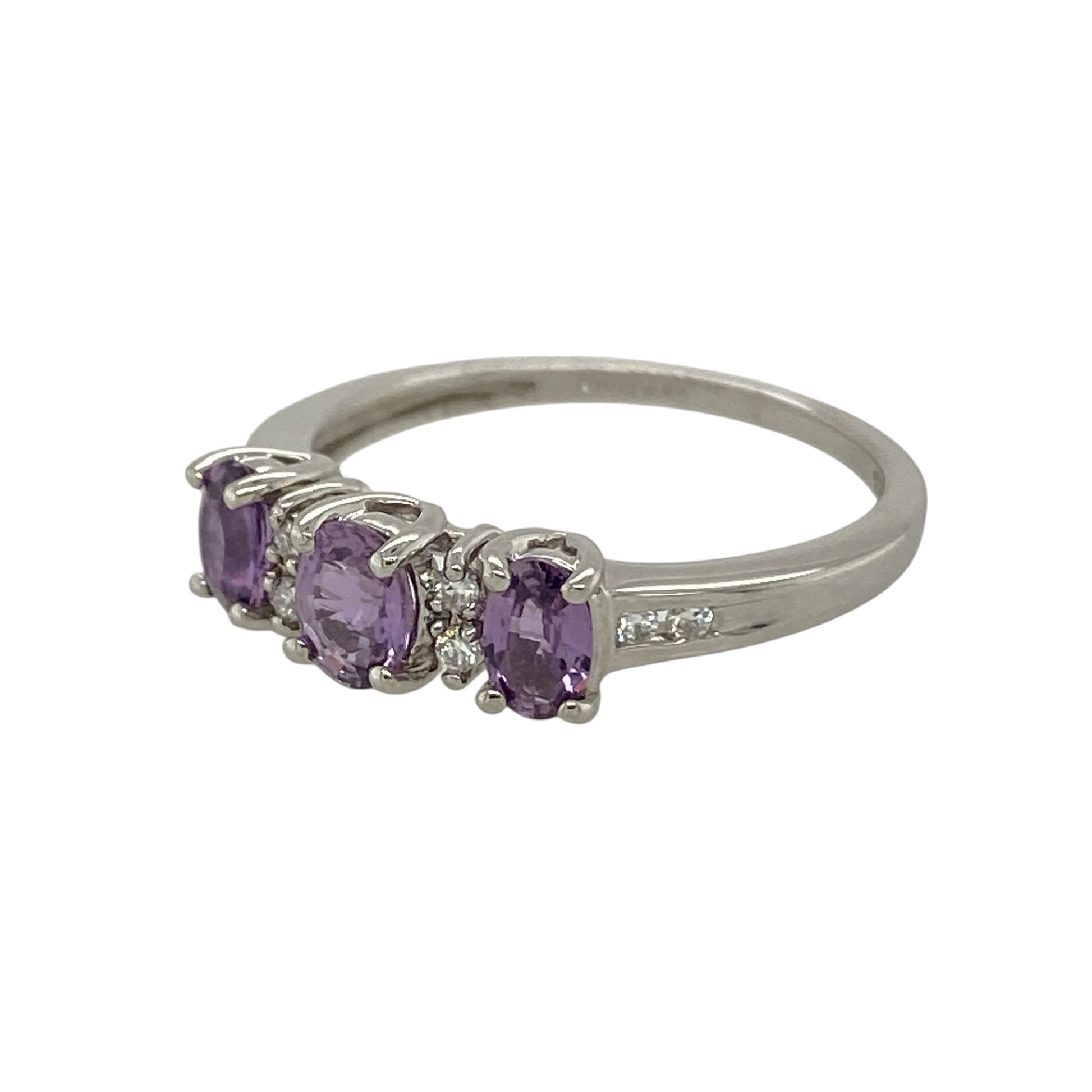 Add elegant colour and refined sparkle to your jewellery collection with this pre-owned 9ct white gold diamond and amethyst set ring—an eye-catching piece perfect for both everyday wear and special occasions.

Design: The ring features a beautiful oval amethyst at the centre, measuring approximately 5mm by 4mm, showcasing rich purple tones and natural brilliance. Sparkling diamond accents complement the centre stone, creating a balanced and timeless silhouette.