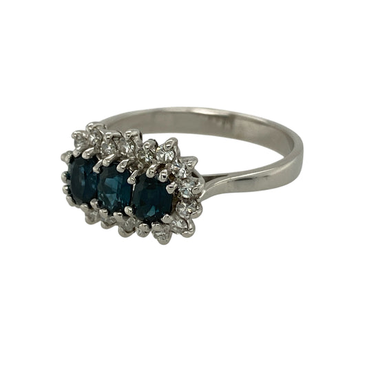Add timeless elegance and rich colour to your jewellery collection with this pre-owned 9ct white gold diamond and sapphire trilogy cluster ring, combining classic gemstones with refined sparkle—ideal as an engagement ring or special occasion piece.

Design: The ring features three oval sapphires, each measuring 5mm by 3mm, arranged in a striking trilogy formation.