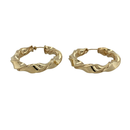 Add classic texture and timeless style to your jewellery collection with these pre-owned 9ct yellow gold twisted hoop creole earrings, offering a bold yet elegant design—perfect for everyday wear or special occasions.

Design: The earrings feature a traditional hoop creole shape with a twisted pattern running along the surface, creating beautiful light-catching detail. The twist design adds depth and character while maintaining the classic hoop silhouette.