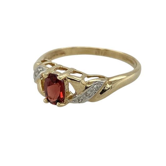 Add rich colour and elegant movement to your jewellery collection with this pre-owned 9ct yellow gold diamond and garnet twist ring, combining classic gemstones with a graceful flowing design—perfect as a dress ring or meaningful gift.

Design: The ring features a 6mm by 4mm oval garnet at the centre, complemented by a sparkling diamond on either side. The twist design along the shoulders draws the eye toward the deep red garnet, creating a soft and elegant silhouette.