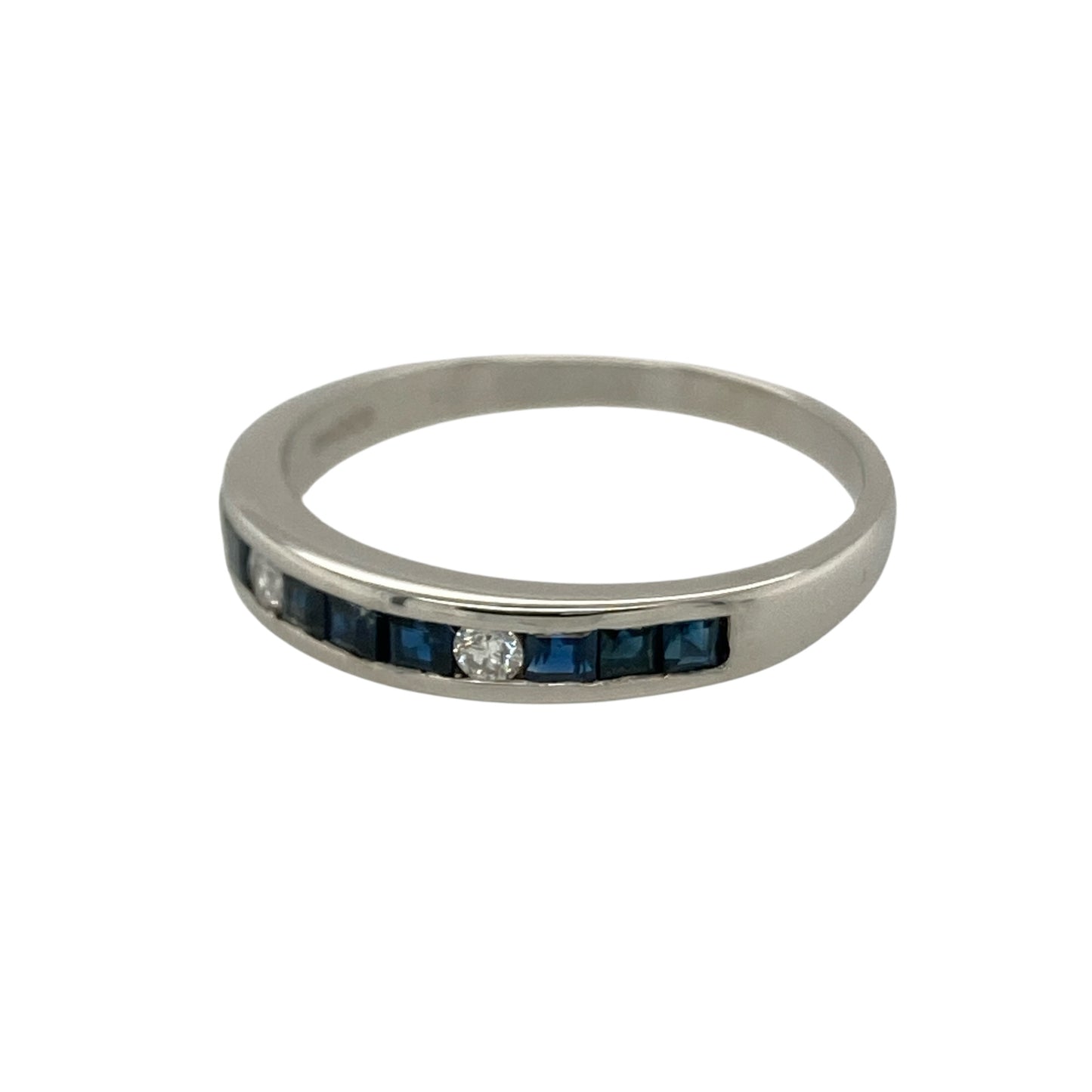 Add rich colour and timeless elegance to your jewellery collection with this pre-owned 9ct white gold diamond and sapphire set band ring, combining classic gemstones with a refined and versatile design—perfect for everyday wear or a meaningful gift.

Design: The front of the band measures approximately 3mm wide and features multiple square cut sapphires arranged across the centre, complemented by two sparkling diamonds.