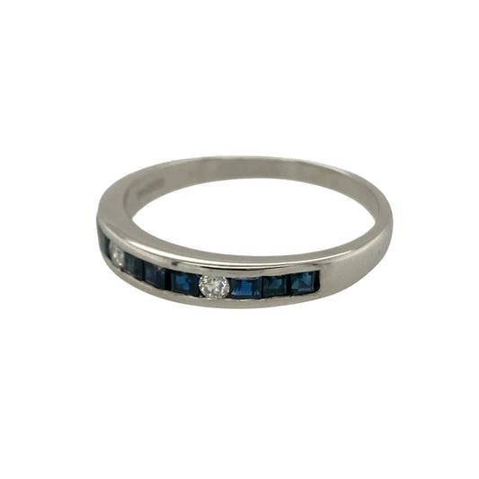 Add rich colour and timeless elegance to your jewellery collection with this pre-owned 9ct white gold diamond and sapphire set band ring, combining classic gemstones with a refined and versatile design—perfect for everyday wear or a meaningful gift.

Design: The front of the band measures approximately 3mm wide and features multiple square cut sapphires arranged across the centre, complemented by two sparkling diamonds.