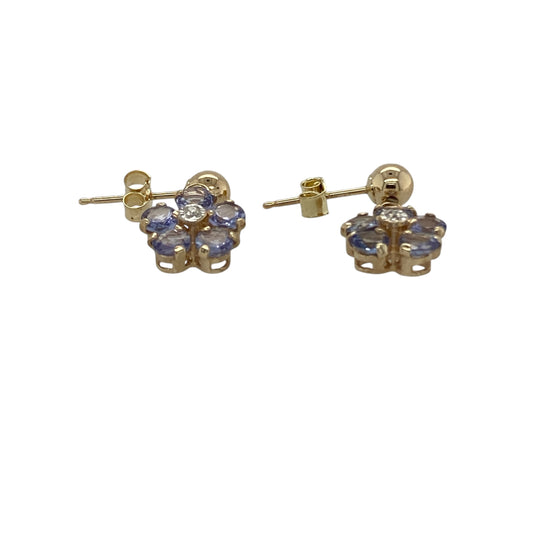Add delicate colour and feminine charm to your jewellery collection with these pre-owned 9ct yellow gold diamond and tanzanite flower drop earrings, featuring a graceful floral design—perfect for everyday elegance or special occasions.

Design: The earrings feature a pretty flower motif set with vibrant tanzanite stones, complemented by sparkling diamond accents. The floral design creates a soft and elegant look while the drop style allows gentle movement when worn. 