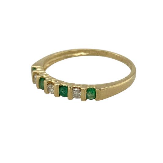 Add vibrant colour and delicate sparkle to your jewellery collection with this pre-owned 18ct yellow gold diamond and emerald set band ring, featuring a timeless combination of classic gemstones—perfect for everyday wear or a meaningful gift.

Design: The band is set with rich green emerald stones measuring approximately 2mm wide, complemented by sparkling diamonds across the front.