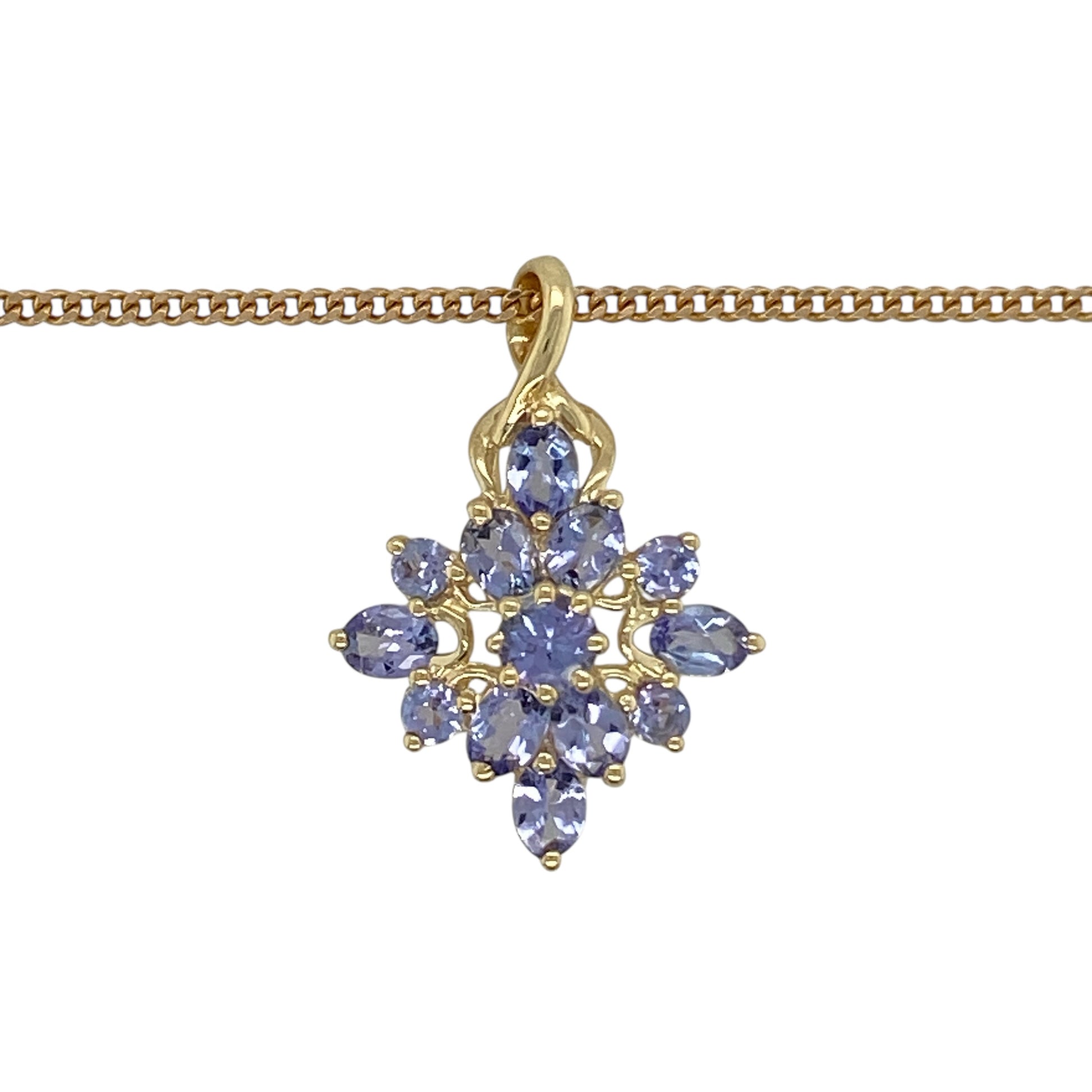 Add vibrant colour and elegant sparkle to your jewellery collection with this pre-owned 9ct yellow gold tanzanite cluster pendant necklace, featuring a striking gemstone arrangement—perfect for special occasions or everyday elegance.

Design: The pendant showcases a beautiful cluster of tanzanite stones arranged to create a rich display of violet-blue colour and brilliance. Measuring approximately 2.5cm in length including the bail, the pendant offers a noticeable yet elegant presence.