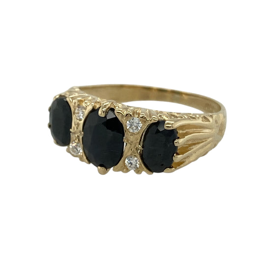 Add timeless colour and elegant sparkle to your jewellery collection with this pre-owned 9ct yellow gold sapphire and cubic zirconia trilogy ring, featuring a classic three stone design—perfect for everyday elegance or a meaningful gift.

Design: The ring features a beautiful oval sapphire at the centre measuring approximately 7mm by 5mm, flanked by additional sapphires with sparkling cubic zirconia stones positioned in between.