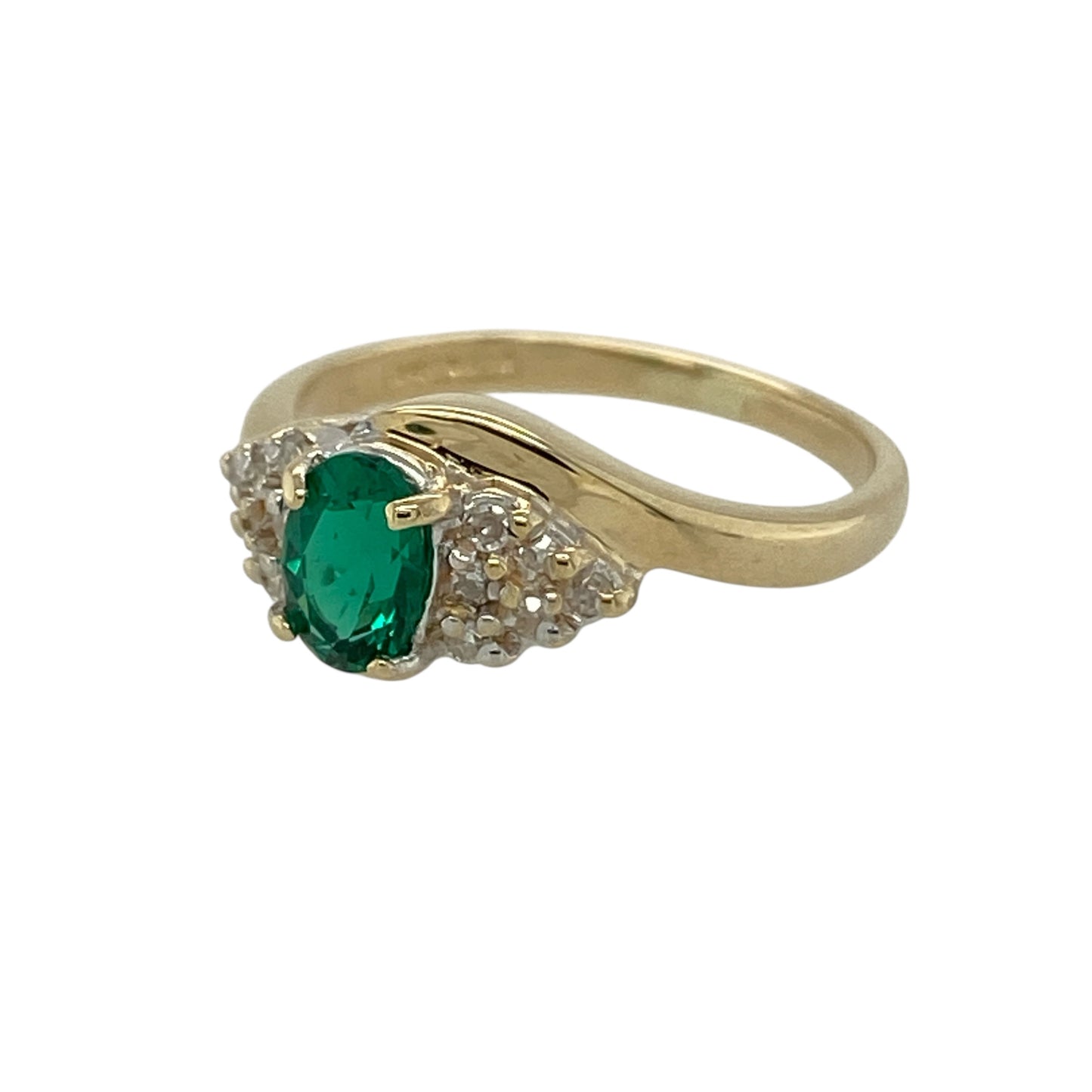Add vibrant colour and elegant sparkle to your jewellery collection with this pre-owned 9ct yellow gold green stone and cubic zirconia ring, featuring a classic gemstone design—perfect for everyday wear or a stylish dress ring.

Design: The ring features an oval green emerald-coloured stone at the centre measuring approximately 6mm by 4mm, creating a striking focal point. The centre stone is complemented by sparkling cubic zirconia accents that enhance its colour and add extra brilliance.