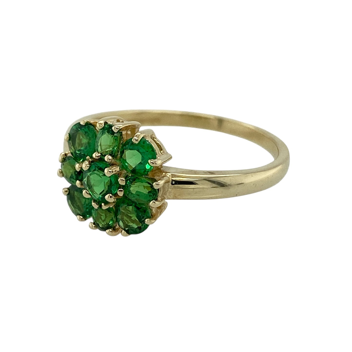 Add vibrant colour and delicate charm to your jewellery collection with this pre-owned 9ct yellow gold green stone flower cluster ring, featuring a classic floral design—perfect for everyday wear or as a thoughtful gift.

Design: The ring showcases a pretty flower cluster arrangement with a green centre stone measuring approximately 3mm, surrounded by additional green stones that form petal-like accents. The floral layout creates a balanced and eye-catching display of rich colour.
