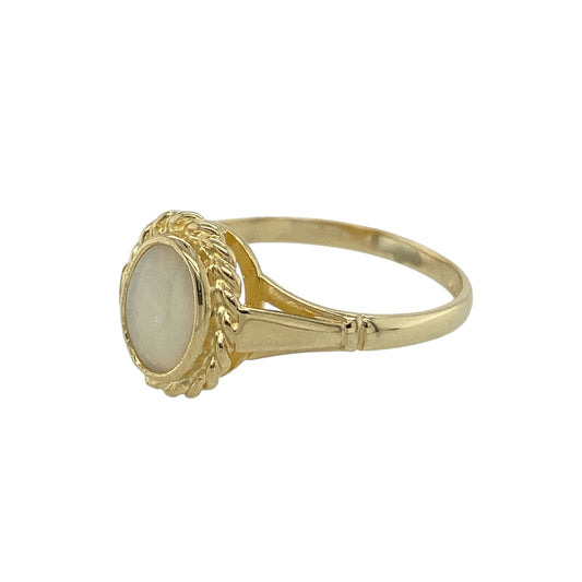 Add soft iridescent colour and vintage-inspired detail to your jewellery collection with this pre-owned 9ct yellow gold opalique solitaire ring, featuring an elegant gemstone and decorative setting—perfect for everyday wear or as a distinctive gift.

Design: The ring features an oval opalique stone measuring approximately 7mm by 5mm, creating a delicate focal point with subtle flashes of colour. A rope-style border surrounds the stone, adding texture and a classic decorative finish to the design.
