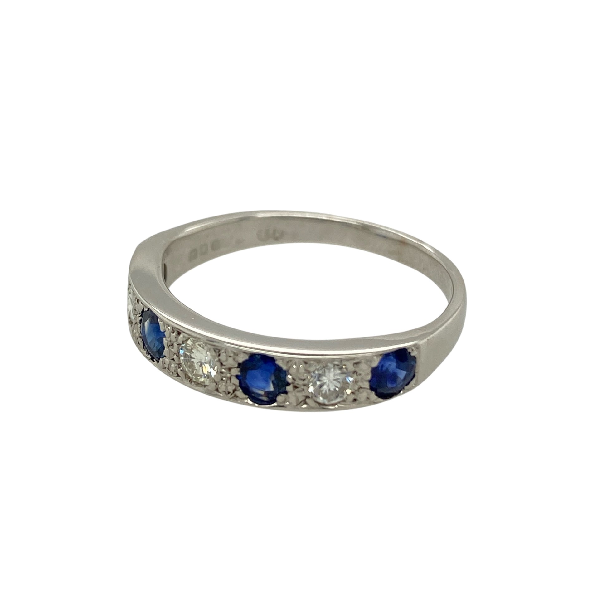 Add refined sparkle and rich colour to your jewellery collection with this pre-owned 18ct white gold diamond and sapphire band ring, featuring a timeless combination of classic gemstones—perfect for everyday elegance or a meaningful gift.

Design: The band features alternating diamonds and deep blue sapphires arranged across the front, creating a balanced and eye-catching display. 