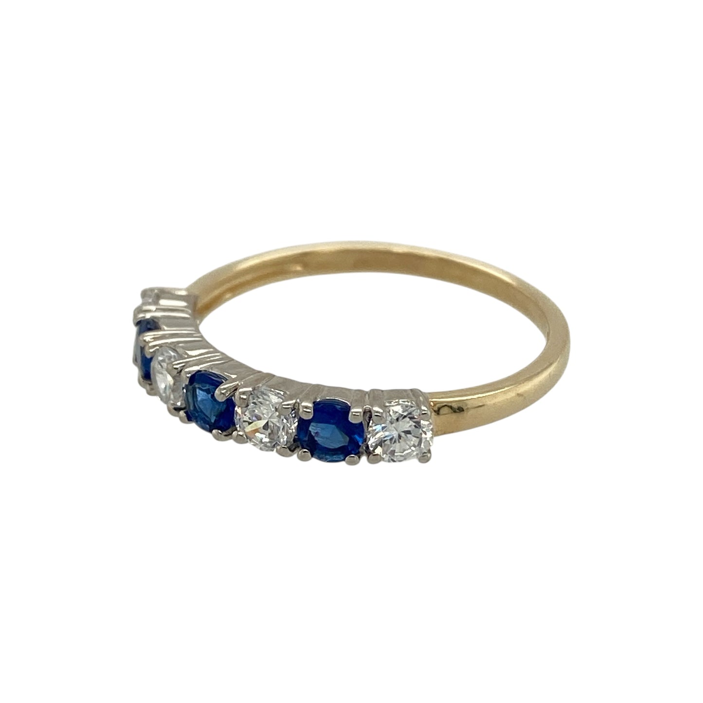 Add vibrant colour and delicate sparkle to your jewellery collection with this pre-owned 9ct yellow gold cubic zirconia and blue stone band ring, featuring a classic gemstone arrangement—perfect for everyday wear or a stylish dress ring.

Design: The band is set with alternating blue stones and sparkling cubic zirconia, each measuring approximately 3mm, creating a balanced and eye-catching display of colour and brilliance across the front of the ring.

