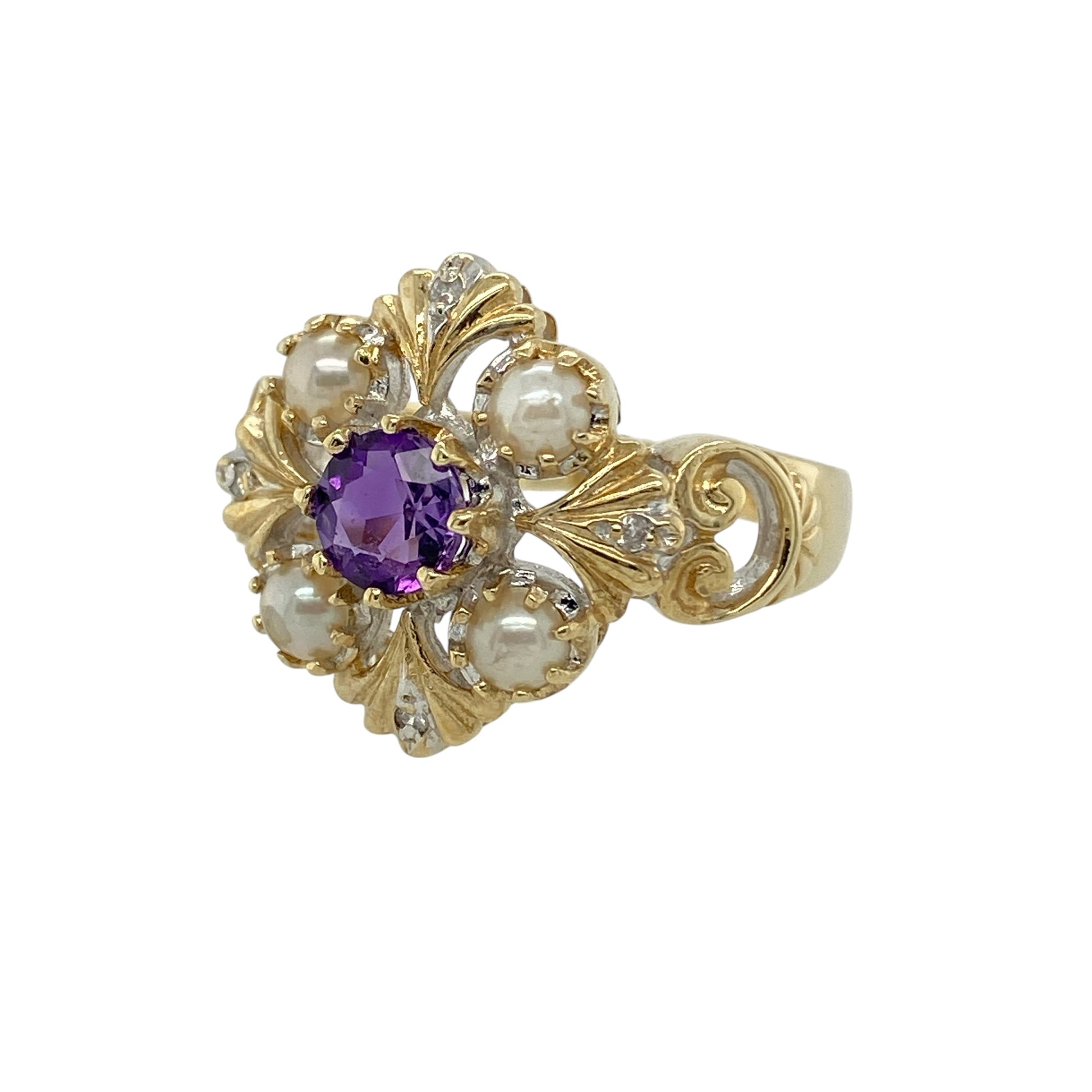 Add vintage-inspired elegance and beautiful colour to your jewellery collection with this pre-owned 9ct yellow gold diamond, purple stone and pearl ring, featuring a distinctive cluster design—perfect as a statement dress ring or unique addition to any jewellery collection.

Design: The ring showcases a decorative vintage style arrangement with purple stones measuring approximately 5mm, complemented by lustrous pearls measuring around 3mm.