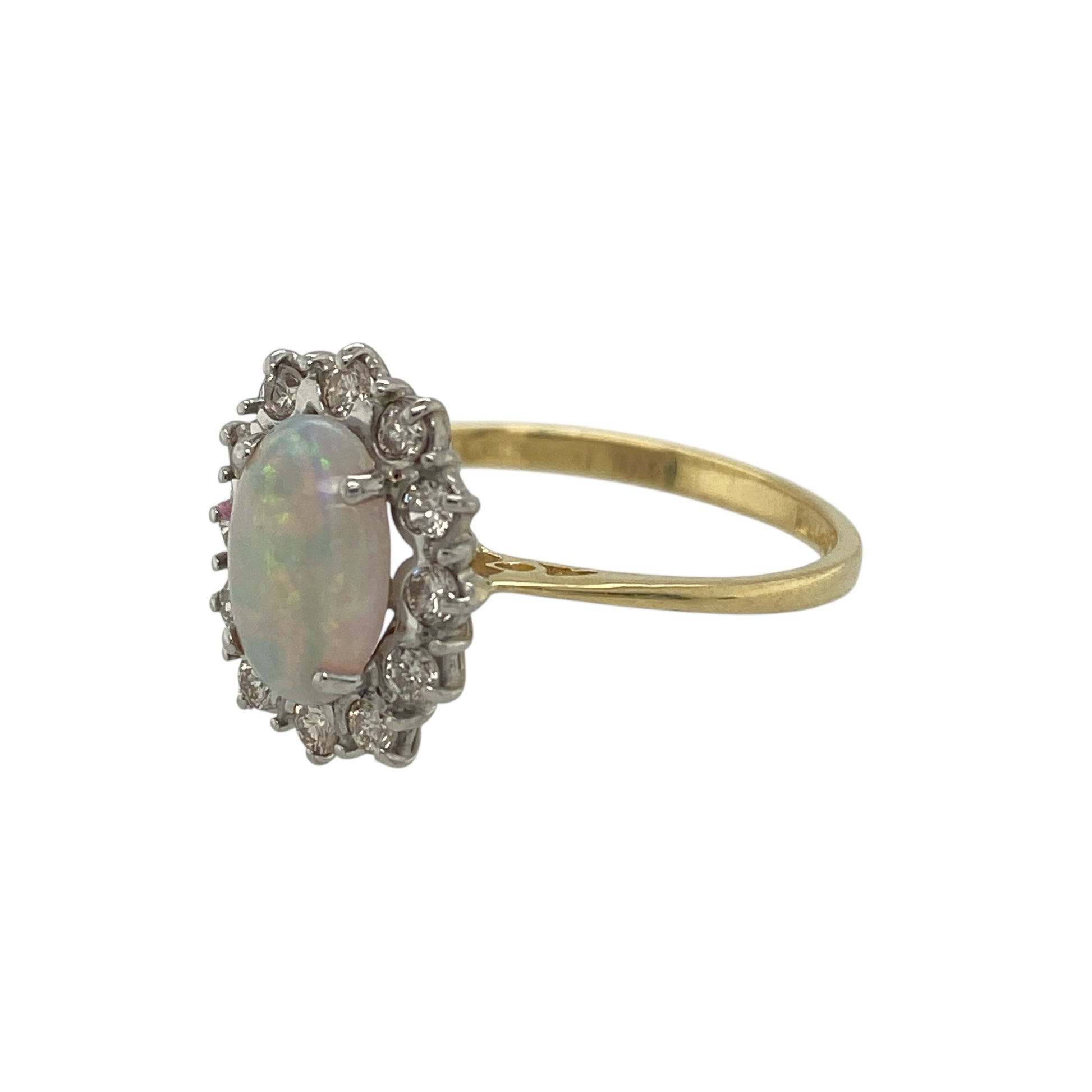 Add beautiful iridescent colour and refined sparkle to your jewellery collection with this pre-owned 18ct yellow gold diamond and opal cluster ring, featuring a timeless gemstone design—perfect for everyday elegance or special occasions.

Design: The ring showcases an oval opal at the centre measuring approximately 9mm by 6mm, displaying soft flashes of colour that create a captivating focal point. 