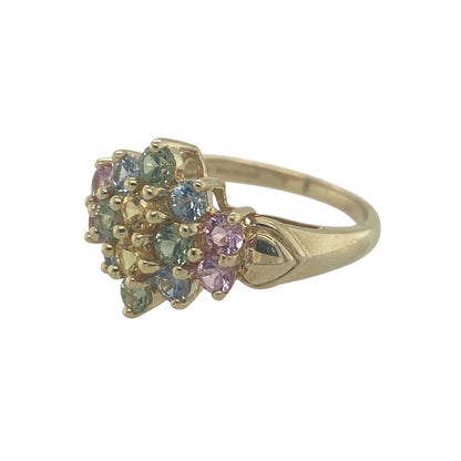 Add vibrant colour and playful elegance to your jewellery collection with this pre-owned 9ct yellow gold multi coloured topaz flower cluster ring, featuring a bright floral design with eye-catching sparkle—perfect for everyday wear or as a standout statement piece.

Design: The ring showcases a flower cluster arrangement set with multi coloured topaz gemstones, each measuring approximately 2mm. 