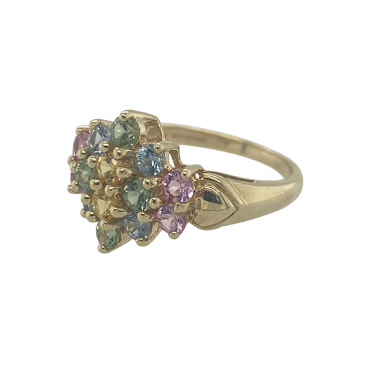 Add vibrant colour and playful elegance to your jewellery collection with this pre-owned 9ct yellow gold multi coloured topaz flower cluster ring, featuring a bright floral design with eye-catching sparkle—perfect for everyday wear or as a standout statement piece.

Design: The ring showcases a flower cluster arrangement set with multi coloured topaz gemstones, each measuring approximately 2mm. 