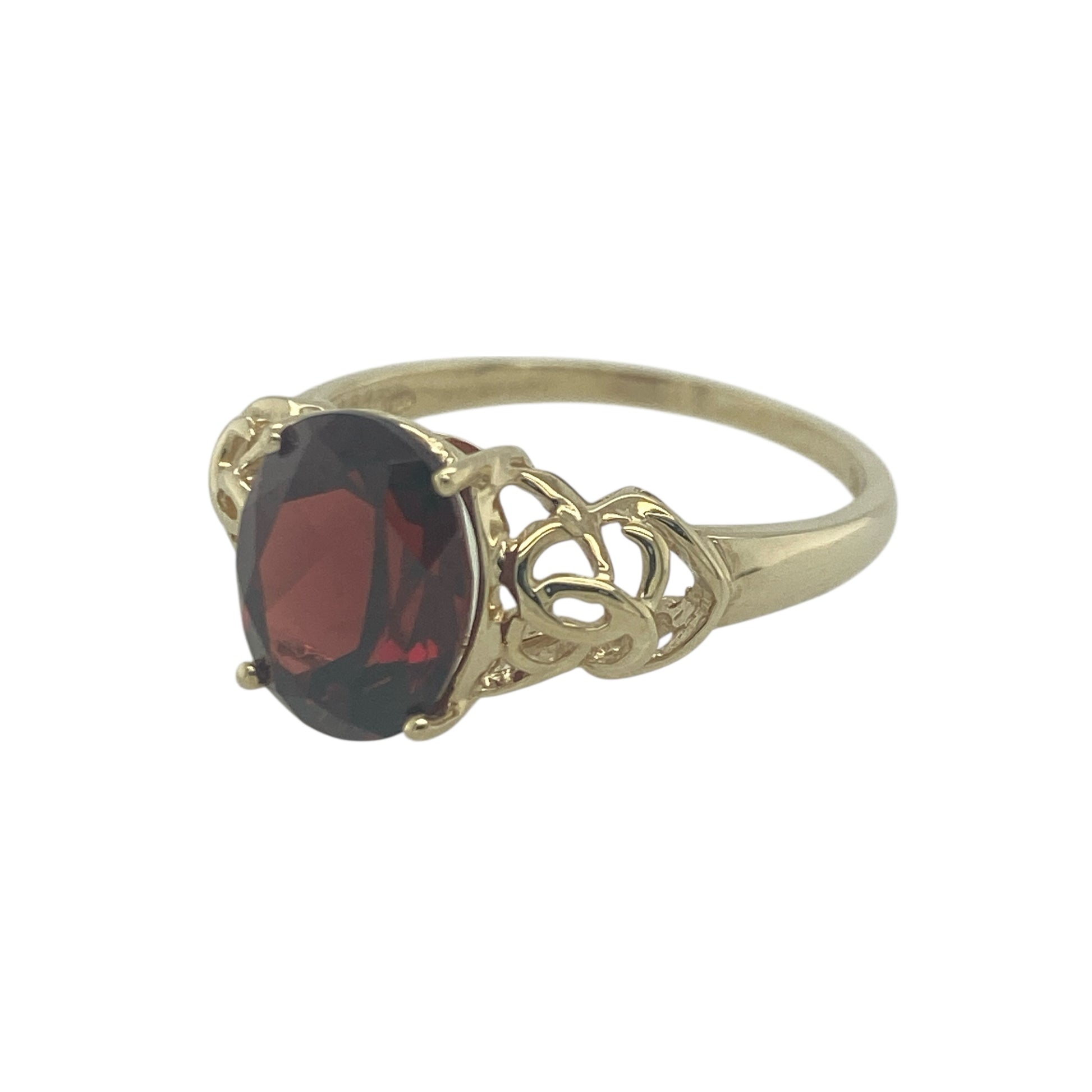 Add bold colour and intricate design to your jewellery collection with this pre-owned 9ct yellow gold red stone Celtic style solitaire ring, featuring a striking gemstone and detailed setting—perfect for making a statement or adding character to everyday wear.

Design: The ring showcases a large oval red gemstone measuring approximately 10mm by 8mm, presented in a solitaire style. The Celtic-inspired detailing adds an ornate and distinctive touch, creating a unique and eye-catching design.
