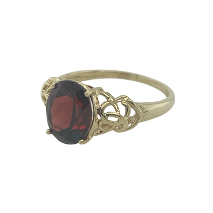 Add bold colour and intricate design to your jewellery collection with this pre-owned 9ct yellow gold red stone Celtic style solitaire ring, featuring a striking gemstone and detailed setting—perfect for making a statement or adding character to everyday wear.

Design: The ring showcases a large oval red gemstone measuring approximately 10mm by 8mm, presented in a solitaire style. The Celtic-inspired detailing adds an ornate and distinctive touch, creating a unique and eye-catching design.
