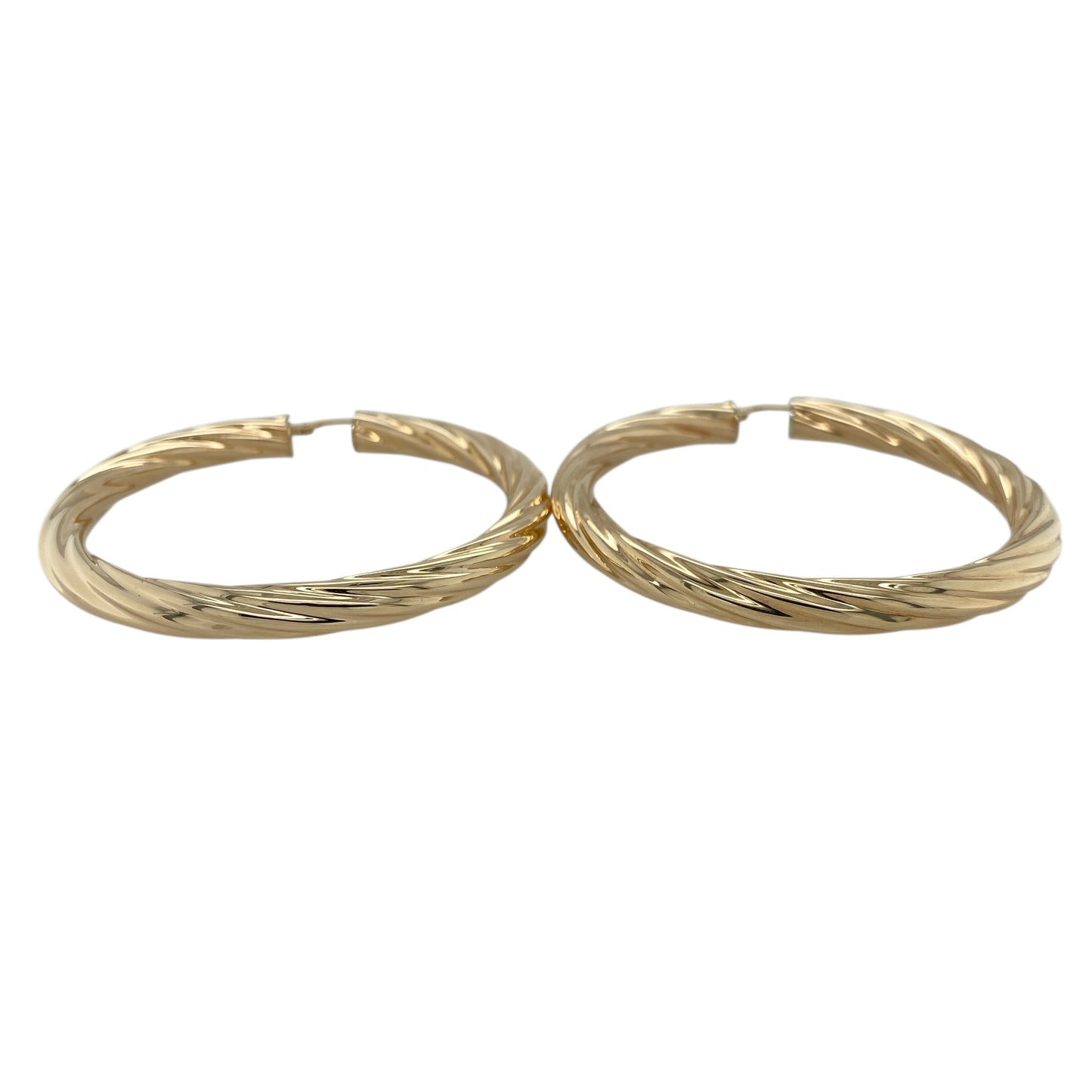 Make a bold statement with these pre-owned 9ct yellow gold twisted large hoop creole earrings, combining classic hoop styling with striking presence—perfect for elevating both everyday and occasion wear.

Design: The earrings feature a large hoop creole style with an elegant twisted design, creating a dynamic look that catches the light from every angle.
Material: Made from 9-carat yellow gold, they have a polished finish that enhances their warm tone and emphasises the sculpted twist.