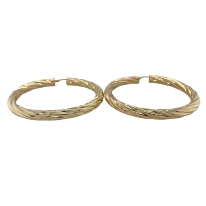 Make a bold statement with these pre-owned 9ct yellow gold twisted large hoop creole earrings, combining classic hoop styling with striking presence—perfect for elevating both everyday and occasion wear.

Design: The earrings feature a large hoop creole style with an elegant twisted design, creating a dynamic look that catches the light from every angle.
Material: Made from 9-carat yellow gold, they have a polished finish that enhances their warm tone and emphasises the sculpted twist.