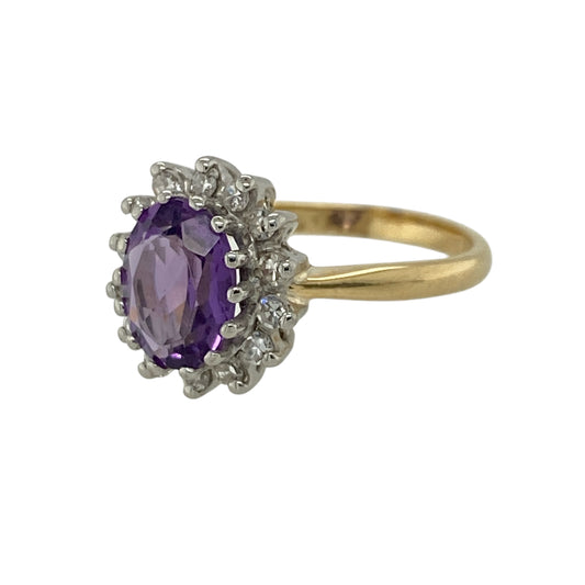 Add a touch of rich colour and elegance to your jewellery collection with this pre-owned 18ct yellow gold diamond and amethyst set cluster ring, combining classic design with vibrant sparkle—perfect for special occasions or everyday luxury.

Design: The ring features a traditional cluster design, centred with an oval amethyst and surrounded by sparkling diamonds, creating a bold and eye-catching look.