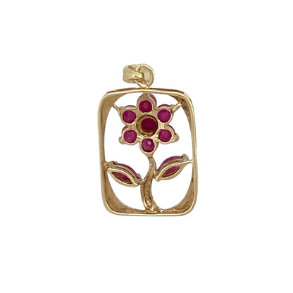 Add a touch of colour and vintage-inspired charm to your jewellery collection with this pre-owned 9ct yellow gold ruby set flower in a rectangle surround pendant, combining classic design with elegant detail—perfect for everyday wear or special occasions.

Design: The pendant features a floral motif set within a rectangular frame, creating a structured yet delicate look with a timeless appeal.