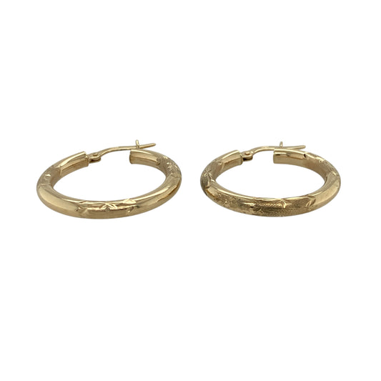 Add a touch of texture and timeless style to your jewellery collection with these pre-owned 9ct yellow gold patterned hoop creole earrings, offering classic design with decorative detail—perfect for everyday wear.

Design: The earrings feature a traditional hoop creole shape with an all-over patterned finish, creating subtle sparkle and visual interest.
Material: Made from 9-carat yellow gold, they have a polished and textured surface that enhances their warm tone and decorative appeal.