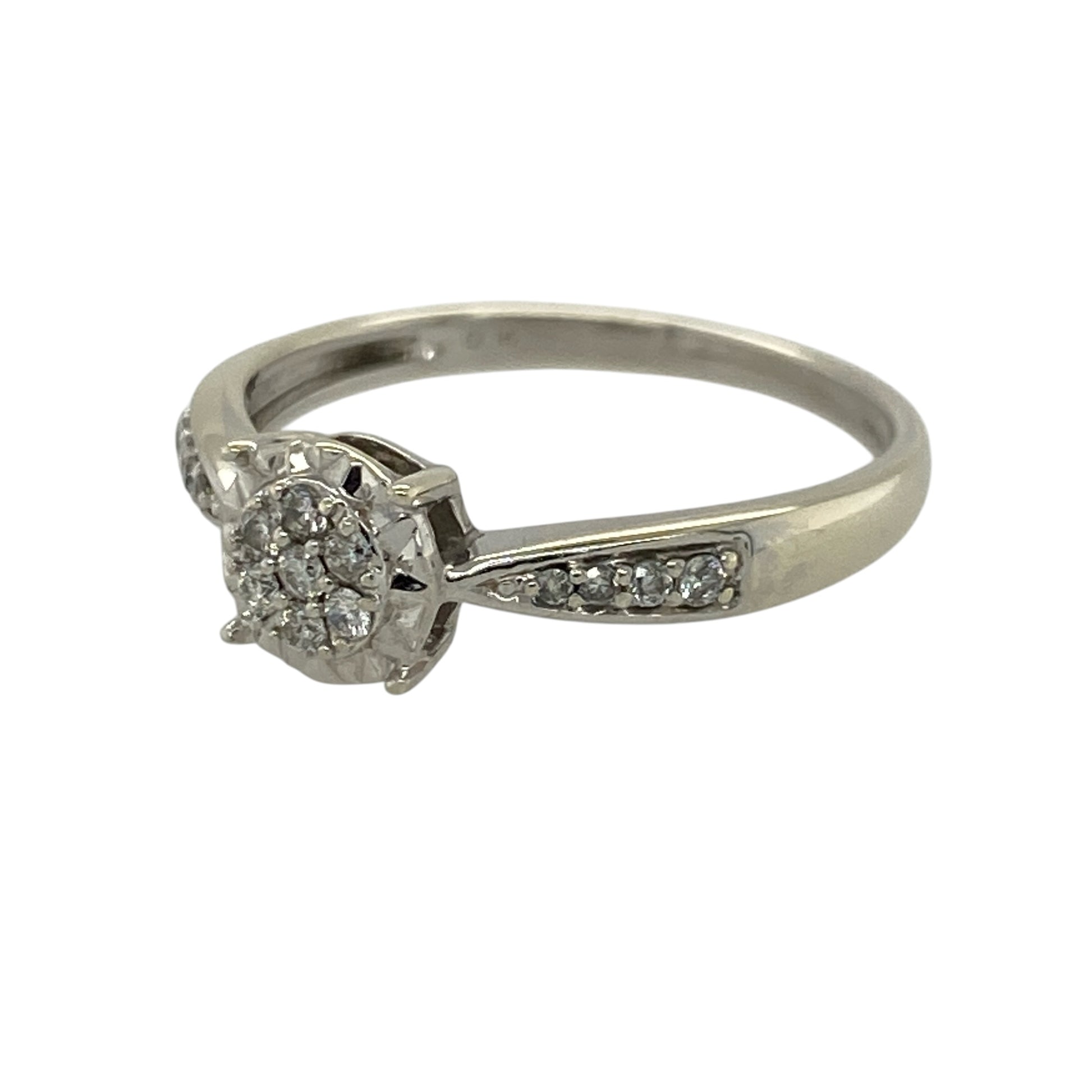 Add a touch of brilliance to your jewellery collection with this pre-owned 9ct white gold diamond illusion set cluster ring, combining classic design with enhanced sparkle—perfect for everyday wear or special occasions.

Design: The ring features a central illusion set diamond cluster, designed to maximise the appearance of size and sparkle, with additional diamonds set along the shoulders for added elegance.