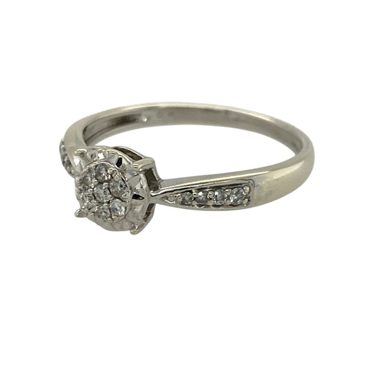 Add a touch of brilliance to your jewellery collection with this pre-owned 9ct white gold diamond illusion set cluster ring, combining classic design with enhanced sparkle—perfect for everyday wear or special occasions.

Design: The ring features a central illusion set diamond cluster, designed to maximise the appearance of size and sparkle, with additional diamonds set along the shoulders for added elegance.