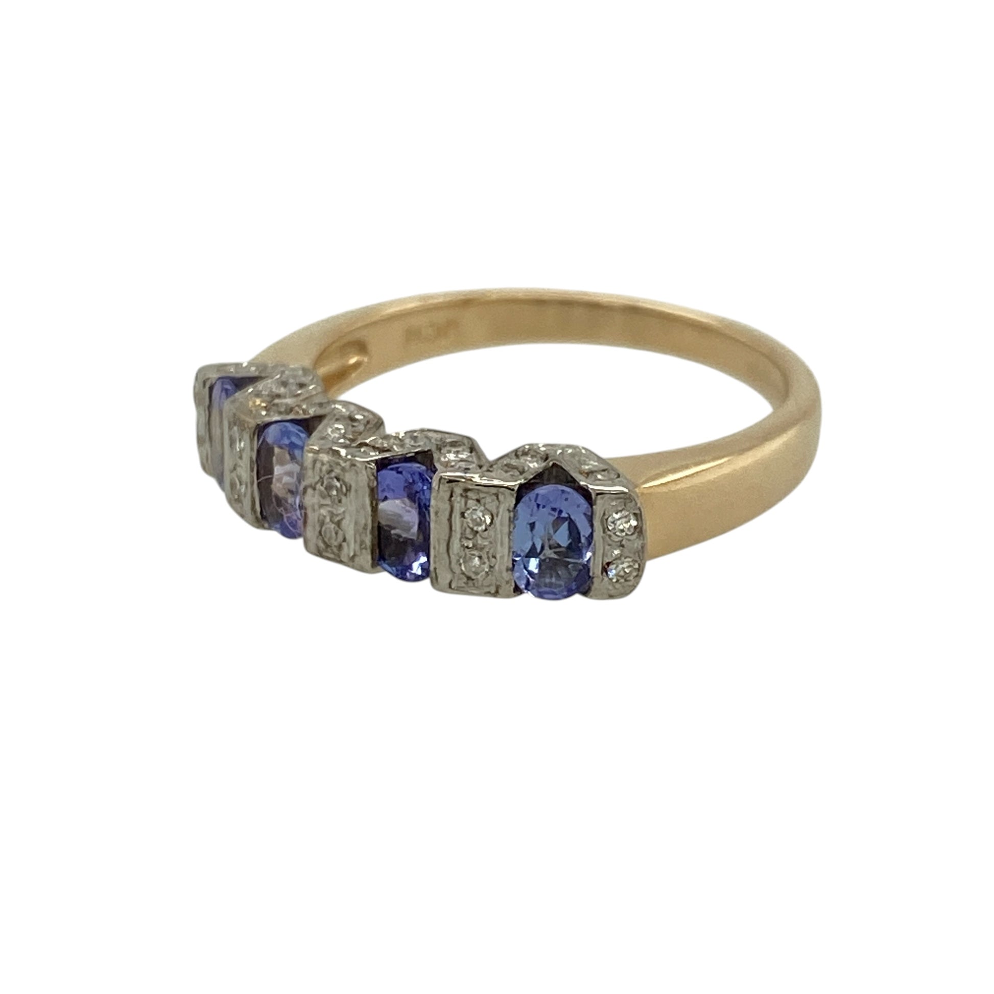 Add a touch of vibrant colour and refined sparkle to your jewellery collection with this pre-owned 14ct yellow and white gold diamond and tanzanite band ring—an elegant choice for both everyday wear and special occasions.

Design: This band ring features a row of captivating tanzanite gemstones, displaying rich violet-blue hues, complemented by sparkling diamonds for added brilliance. The slim 4mm front creates a neat and sophisticated look, perfect for stacking or wearing alone.