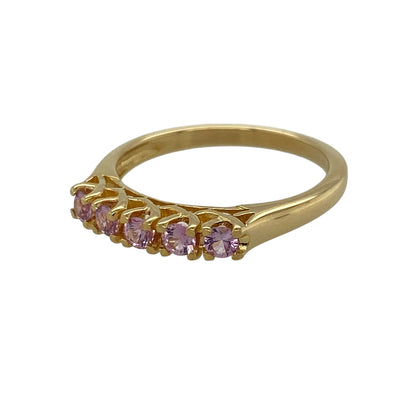 Add a touch of refined colour and elegance to your jewellery collection with this pre-owned 18ct yellow gold pink sapphire set five stone band ring—perfect for both everyday wear and special occasions.

Design: This five stone band ring features a row of round pink sapphires, each measuring approximately 3mm in diameter, creating a beautifully balanced and vibrant display of colour across the finger.